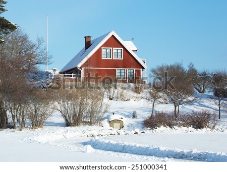 A little more modern red house by the ordinary variety for accommodation of a family., The house is located in the countryside in winter weather