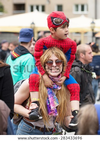 STOCKHOLM, SWEDEN - MAY 31, 2015. Peace and Love Parade. Street party in Stockholm, Boy sitting on a woman\'s shoulder.