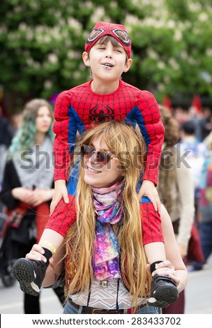 STOCKHOLM, SWEDEN - MAY 31, 2015. Peace and Love Parade. Street party in Stockholm, Boy sitting on a woman\'s shoulders.