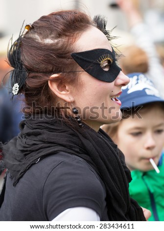 STOCKHOLM, SWEDEN - MAY 31, 2015. Peace and Love Parade. Street party in Stockholm,  Young woman with a black mask over the eyes.