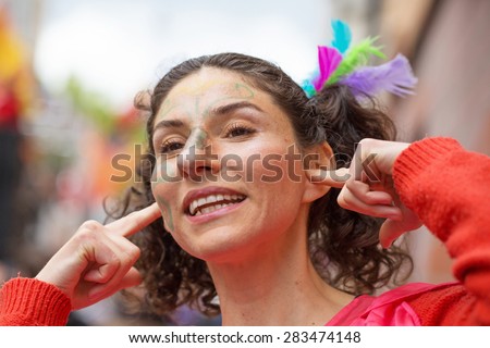 STOCKHOLM, SWEDEN - MAY 31, 2015. Peace and Love Parade. Street party in Stockholm. Woman holding her ears to reduce the noise level from the music.