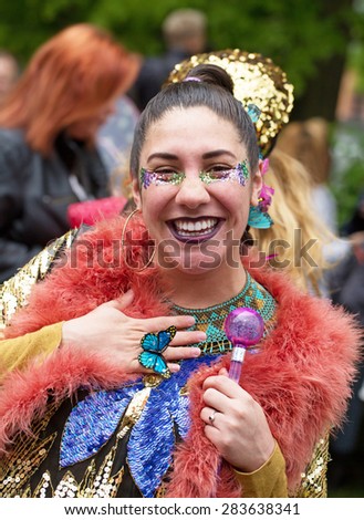 STOCKHOLM, SWEDEN - MAY 31, 2015. Peace and Love Parade. Street party in Stockholm. Painted woman with pearls and strong colors.