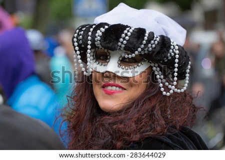 STOCKHOLM, SWEDEN - MAY 31, 2015. Peace and Love Parade. Street party in Stockholm. Painted woman with pearls and  mask.
