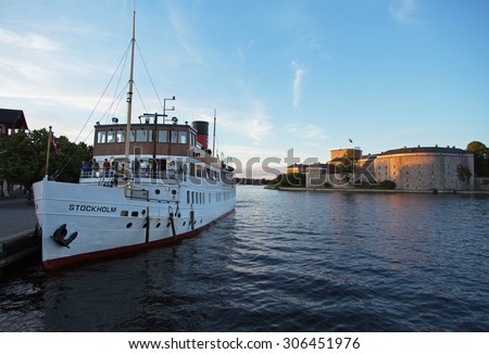 STOCKHOLM-AUG-13-2015. Passenger boat in the Stockholm archipelago. Vaxholm boat Stockholm port to pick up and drop passengers. in the background is the Vaxholm Fortress.