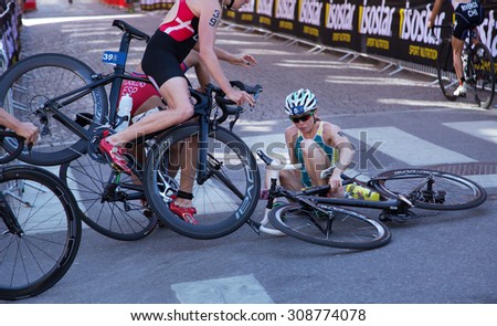 STOCKHOLM - AUG, 22: ITU World Triathlon  event Aug 22, 2015. woman running in Old town. Mc SHANE has fallen, McShane was involved in a crash just after a curve.