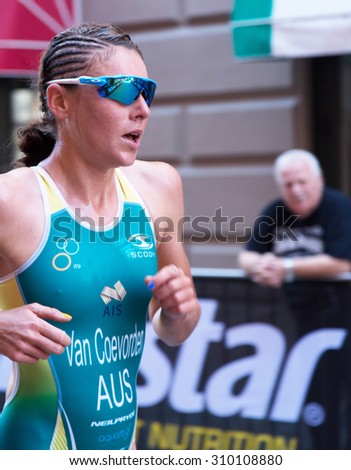 STOCKHOLM - AUG 22: Women ITU World Triathlon event Aug 22, 2015. Woman running in Old town. Van Coevorden Natalie (AUS).