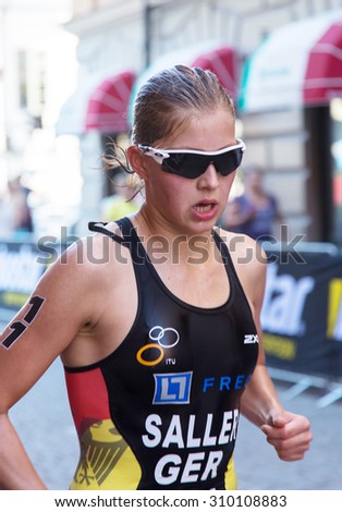 STOCKHOLM - AUG 22: Women ITU World Triathlon event Aug 22, 2015. Woman running in Old town. Saller, Sophia (GER).
