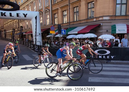 STOCKHOLM - AUG 22: Women ITU World Triathlon event Aug 22 2015. Woman cycling in Old town.