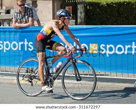 STOCKHOLM - AUG 22: Women ITU World Triathlon event Aug 22 2015. Woman cycling in Old town.Bravo, Elizabeth (ECU).