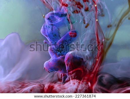 Colors dropped into liquid and photographed while in motion. Ink swirling in water. Cloud of silky ink in water. Colorful ink in water, an abstract banner. Violet, red and blue ink.