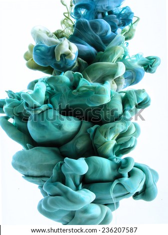 Color drop in water, photographed in motion. Ink swirling in water. Cloud of silky ink in water isolated on white background. Colorful ink in water, ink drop. Turquoise, green, blue color.
