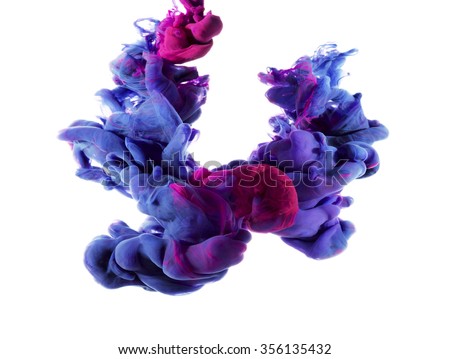 Two drops of color merged under water create colorful organic abstract form and shapes with detailed structures. Blue and magenta ink color swirl.