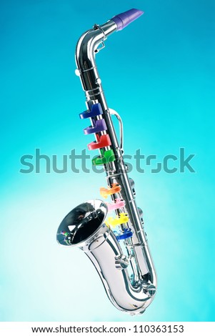 Saxophone, toy isolated on a blue background