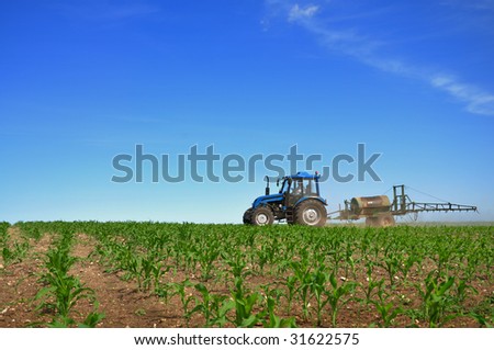 Tractor plowing the fields horizontal