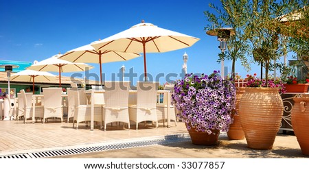 Beach restaurant, chairs and sunshades outdoor