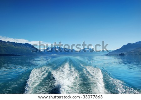 Waves from the boat and deep blue sky under the mountain of Alaska