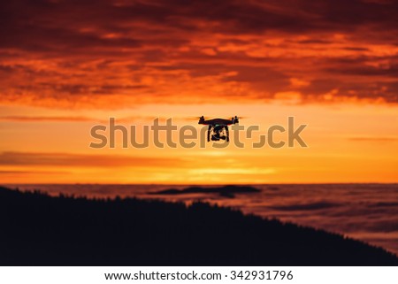 Smolian, Bulgaria - October 15, 2015,: Flying drone quadcopter Dji Phantom 2 with digital camera GoPro HERO4, sunrise shot