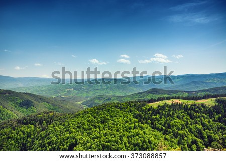 Beautiful mountain landscape, with mountain peaks covered with forest and a cloudy sky. Bulgarian mountains, Europe