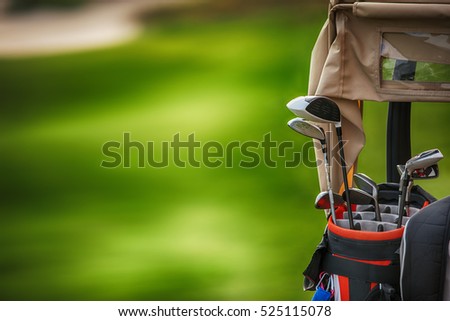 Golf clubs drivers over green field background