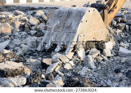 excavator scoop digging on street