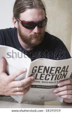 young man studying the General Election guidelines to figure out how to vote