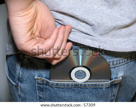 young teen boy shoplifting a cd