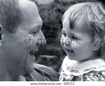Little girl with father talking and laughing together in black and white