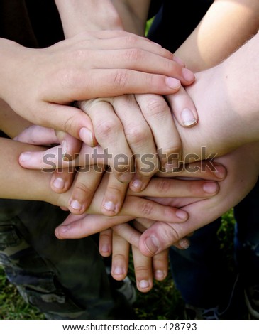 Boys\' team with hands stacked together