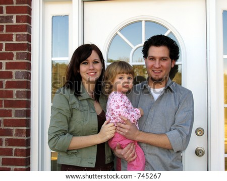 Family at the front door of their new home
