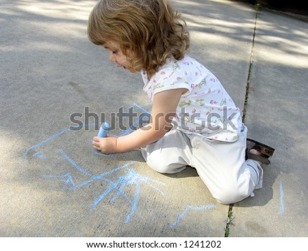 Pre-school age child drawing on sidewalk with colored chalk