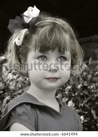 Colorized, tinted black and white portrait of a little girl with a bow in her hair