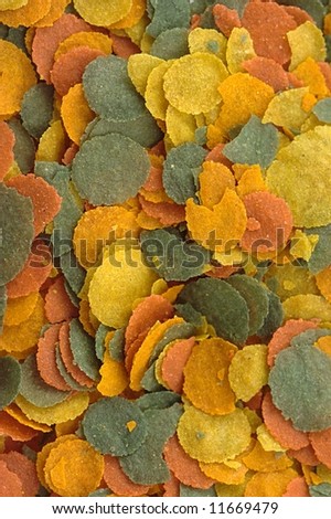 Colored background — scattered colored granules of nutrients for aquarium fish