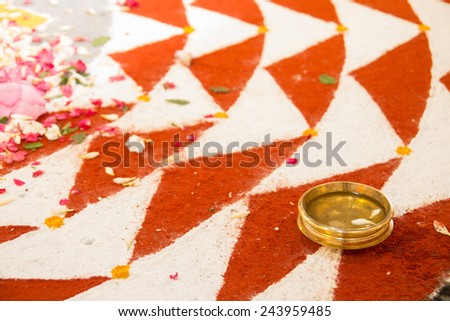 Powder pattern with a copper bowl and flower petals