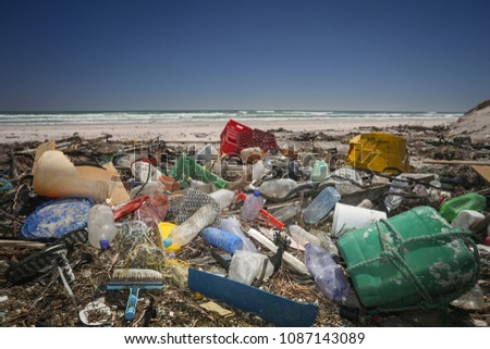 A beach completely polluted by plastic waste washed up by the ocean.