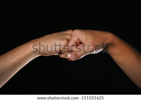 Two hands greeting with a fist bump.