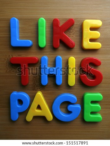 the words like this page spelled out in colorful letters on a wooden surface.