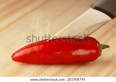 Red Hot Chili being cut, steaming from the inside.