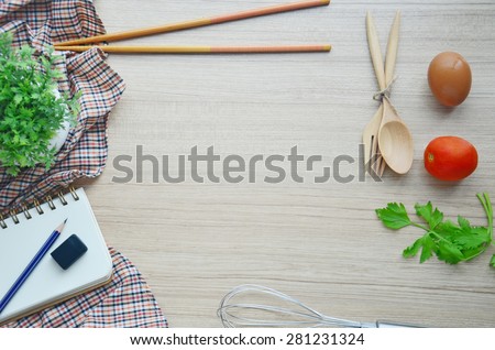 Cooking tools and blank note on the wood table - Top view