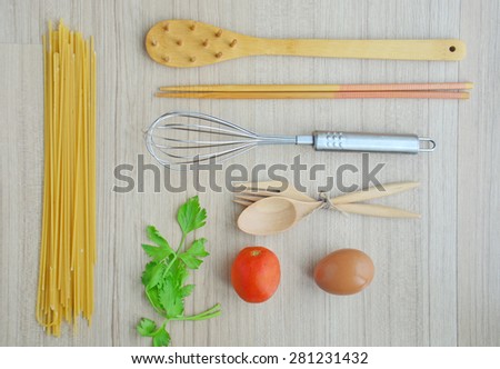 spaghetti and cooking tools on the wood table - Top view