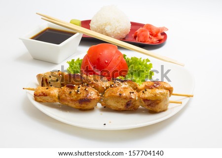 Isolated hot sashlik in japan style with soy sauce rice and vegetables