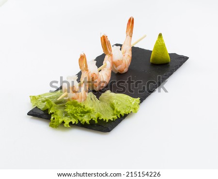 Fried shrimp on a stone plate and white background