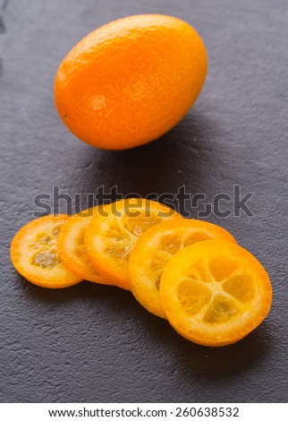 ripe kumquat fruits over stone background