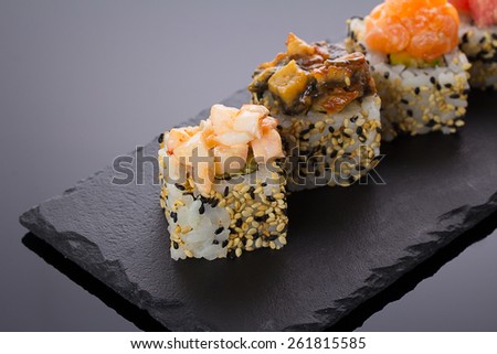 Sushi rolls on a stone plate