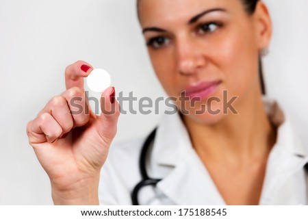 Portrait of a female doctor, holding medicament, isolated on white background.