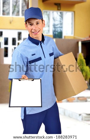 Young delivery man, in front of a house.