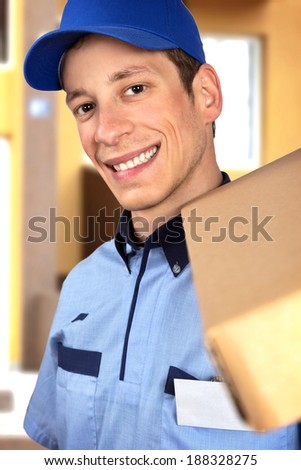 Smiling pizza delivery man holding pizza box.
