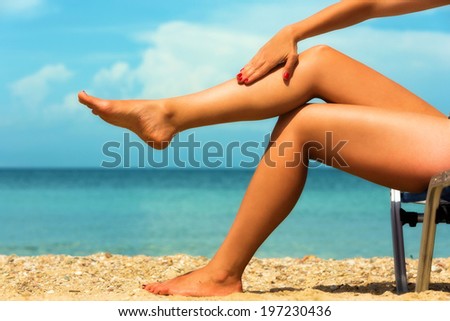 Close up of a female legs at the beach.