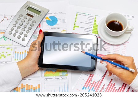 Close up of a business woman doing presentation on tablet, at office desk.