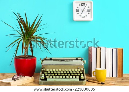 Working desk- typewriter, books and clock on the wall