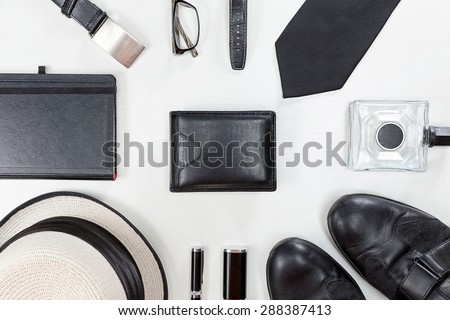 Men accessories. Black elegant accessories pieces isolated on white wooden table. Top view.